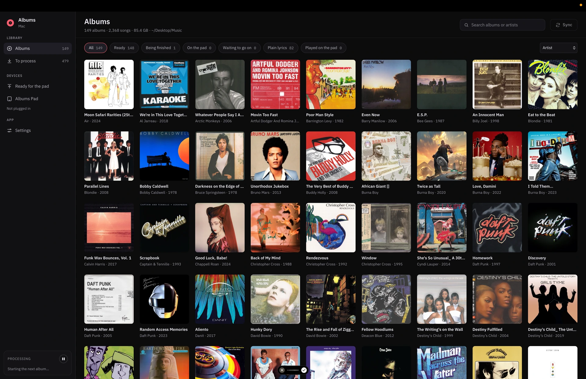 The Albums library showing a collection of album covers in a full-screen music player